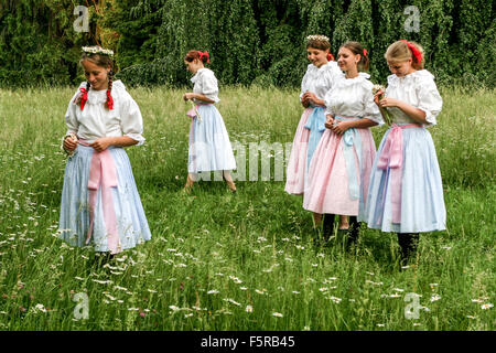 Girls with daisies. Czech women in the traditional scything grass on meadow castle, Buchlovice, South Moravia, Czech Republic girls in costume Stock Photo