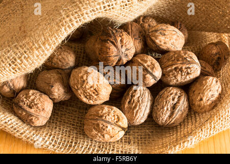 Ripe walnuts in a jute sack. Stock Photo