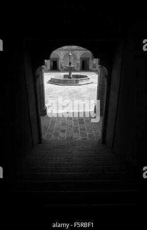 Black and white image of the fountain in the courtyard of Palacio Clavijero in Morelia, Michoacan, Mexico. Stock Photo