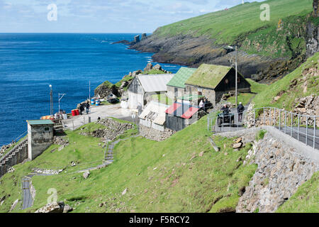 Harbor area on Mykines with blue ocean and landscape Stock Photo