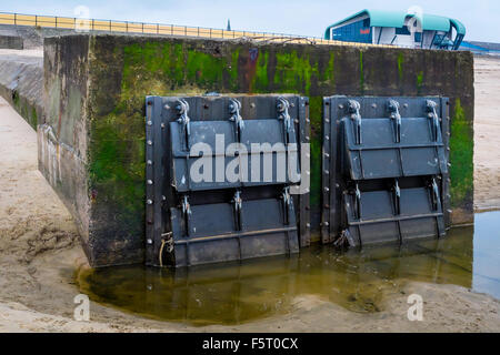 Flood protection storm water drain outlet fitted with new flap non return valves to prevent flooding Stock Photo