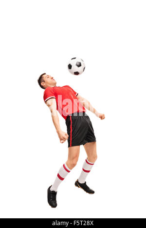 Full length portrait of a young sportsman in red jersey playing football isolated on white background Stock Photo