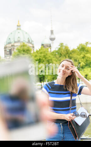 Germany, Berlin, Woman posing for photograph in city