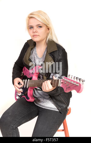 Teenage girl playing electric guitar Stock Photo