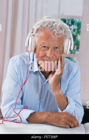 Senior man lenjoying music with headphones Stock Photo