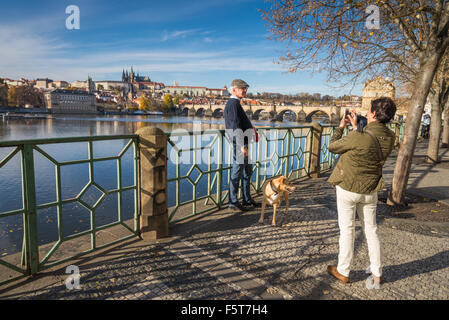 tourists make a picture, background Prague castle and river Vltava, Czech republic Stock Photo