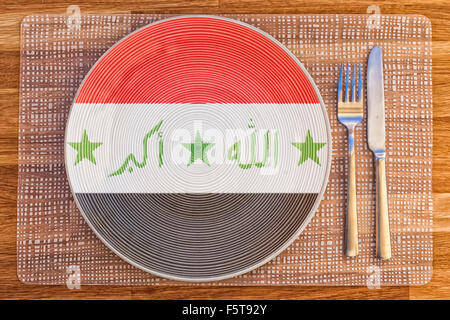 Dinner plate with the flag of Iraq on it for your international food and drink concepts. Stock Photo