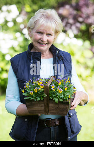 Portrait Of Senior Woman Planting Flowers In Garden Stock Photo - Alamy