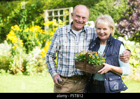 Portrait Of Senior Couple Working In Garden Together Stock Photo