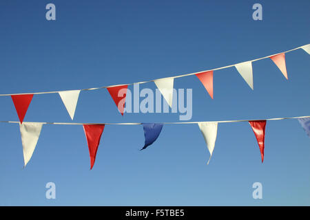 Flags or buntings against a blue sky Stock Photo
