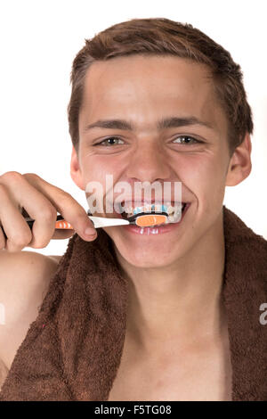 Teenage boy cleaning his teeth Stock Photo