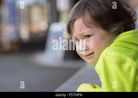 A 3 year old boy with a very upset, stressed expression on his face. Stock Photo