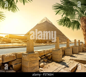 Pyramid of Khafre and asphalted road with columns Stock Photo