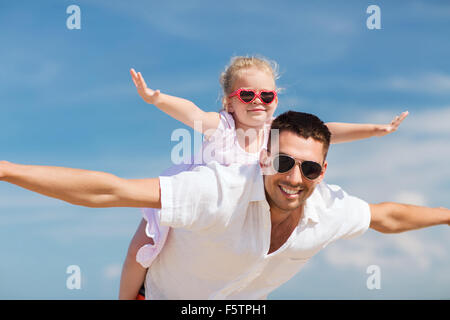 happy family having fun over blue sky background Stock Photo