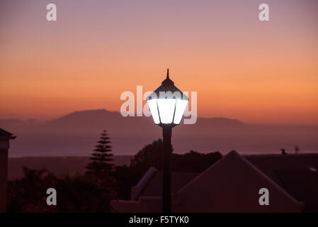 Street light illuminated at dusk Somerset West in the Western Cape South Africa Stock Photo