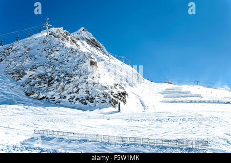 Ski lifts, snow fences and skiers on Hintertux glacier in Zillertal Alps in Austria