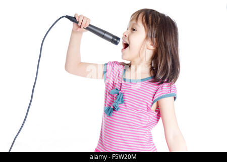 Young Asian American girl singing into microphone Stock Photo