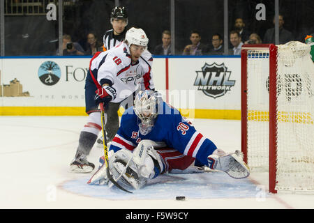 Manhattan, New York, USA. 03rd Nov, 2015. Washington Capitals center Chandler Stephenson (18) reaches around a stretched out New York Rangers goalie Henrik Lundqvist (30) for the puck during the game between The New York Rangers and The Washington Capitals at Madison Square Garden in Manhattan, New York . The New York Rangers defeat The Washington Capitals 5-2. Mandatory credit: Kostas Lymperopoulos/CSM/Alamy Live News Stock Photo