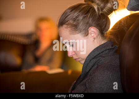 girl looking at digital tablet computer while mother watches Stock Photo