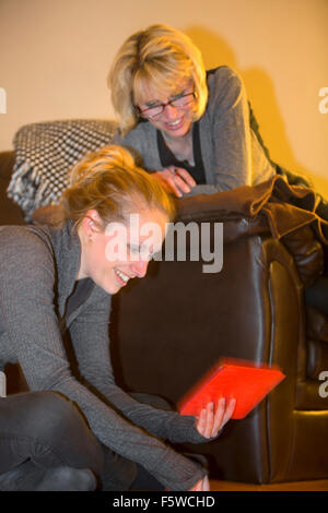 two women using digital tablet computer Stock Photo