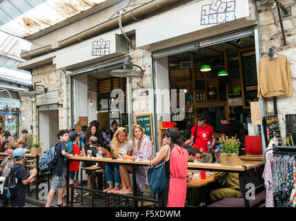 Young crowed sitting in popular restaurants and bars in the Machane Yehuda market in Jerusalem. Stock Photo