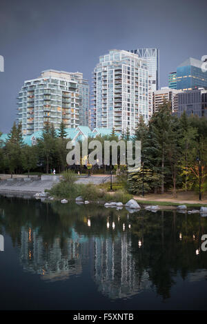 Reflections of downtown buildings in lagoon, Eau Claire market area, Calgary, Canada Stock Photo