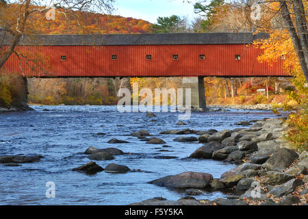 West Cornwall covered bridge over rapids in the Housatonic River, with colorful fall foliage in October, Connecticut. Stock Photo