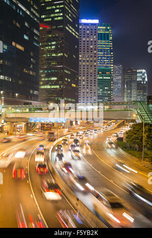 Traffic rushes through the street of Hong Kong central business district at night Stock Photo