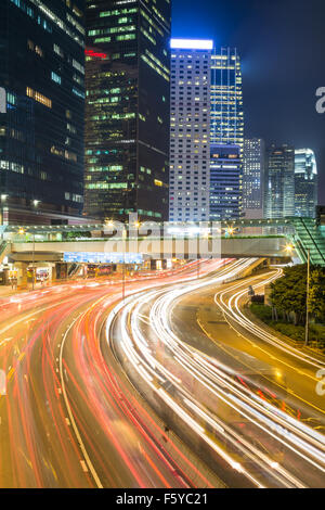 Traffic rushes through the street of Hong Kong central business district at night Stock Photo