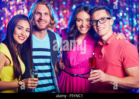 Two amorous couples toasting at nightclub Stock Photo