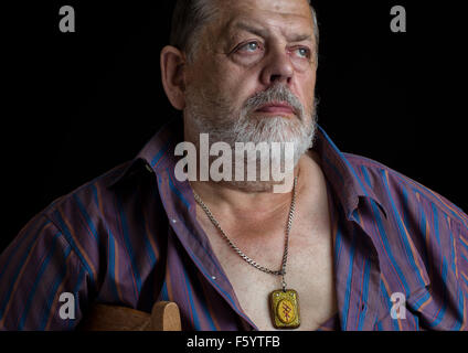 Nice portrait of a imperious senior man in striped shirt Stock Photo