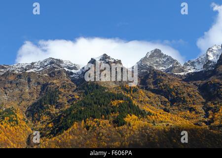 Mountain tops with first snow and colorful autumn forest Stock Photo
