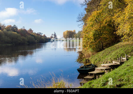 View along River Tweed valley with moored boat by steps in autumn. Kelso, Berwickshire, Scottish Borders, Scotland, UK, Britain Stock Photo