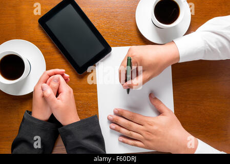 business partners hands on the table top view Stock Photo