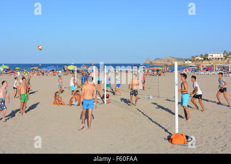 Group of youngsters playing beach volleyball on the Arenal beach, Javea / Xabia, Alicante, Spain, Stock Photo