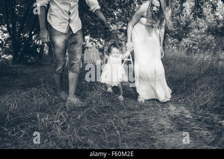 Young family walking in the garden Stock Photo