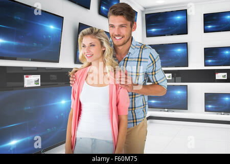 Composite image of attractive young couple smiling together Stock Photo