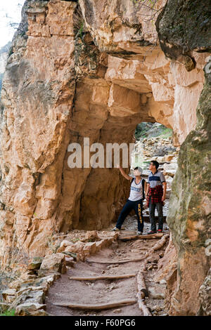 Grand Canyon National Park, Arizona - Two Japanese tourists pause at a tunnel while hiking on the Bright Angel Trail. Stock Photo