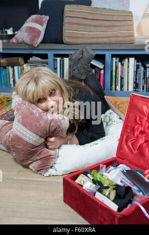 Helen Lederer portraits UK comedy actor and writer showing off some of the home made cushions that she likes to throw together i Stock Photo
