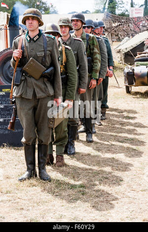 WW2 re-enactment. Outdoors. Full length view of a line of German Stock ...