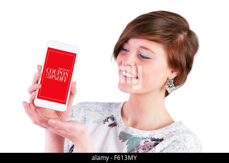 Composite image of smiling woman showing smart phone with blank screen Stock Photo