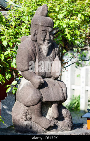 Statue of the Japanese God, Ebisu, aka Webisu, Hiruko god of fishermen and luck. One of the seven gods of good fortune, shichifukujin.. Stock Photo