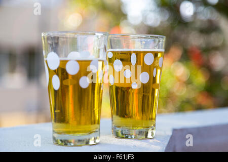 Two glasses of beer on a wall Stock Photo