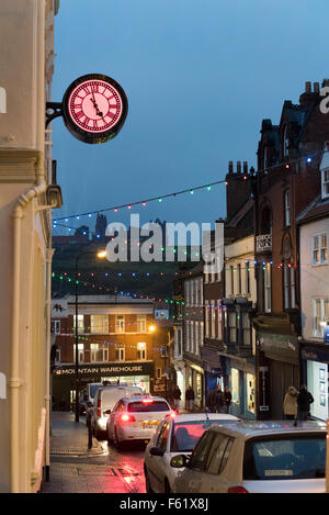 Evening in the resort and fishing port of Whitby, North Yorkshire, UK, with a view of the Abbey on the hill Stock Photo