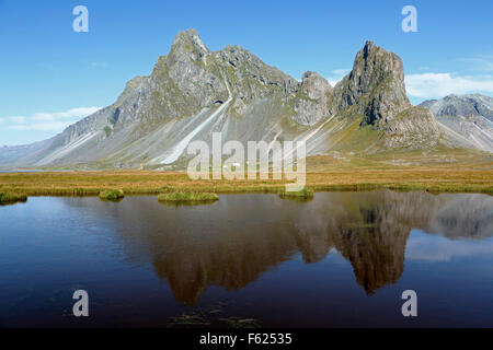 Vikurfjall Mountain reflected on pond, near Hvalnes Nature Reserve, Iceland Stock Photo