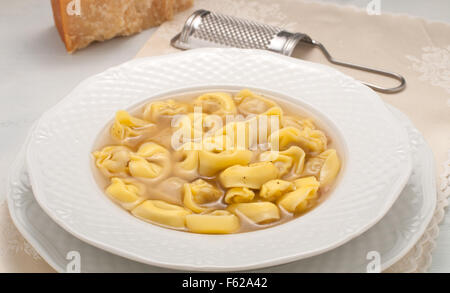 Italian ravioli stuffed with meat cooked in broth with cheese Stock Photo