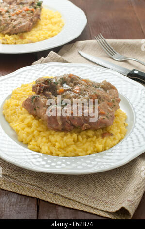marrowbone, veal cut used in Italian cooking with yellow risotto alla milanese with safran Stock Photo