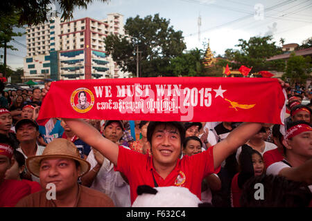 Supporters of Myanmar opposition leader Aung San Suu Kyi react as they look at the official election results outside the National League of Democracy (NLD) headquarters in Yangon . Supporters of Aung San Suu Kyi's pro-democracy party cheered in growing excitement as early results from Myanmar's historic election boosted hopes of sweeping gains to carry it to power after decades of military dominance. Stock Photo