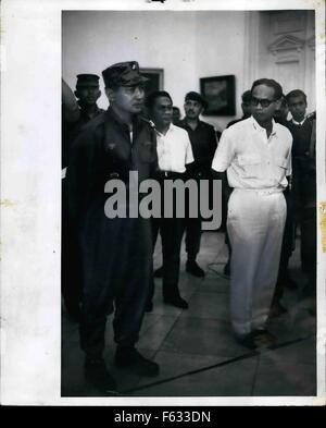 1965 - Maj. Gen Suharto (left in army uniform) at Istana Palace, Djakarta Indonesia, Oct. 14, 1965 when President Sukarno appointed him Army Chief of Staff. Suharto replaces Lt. gen Achmad yani, who was killed by the communists during the Oct. 1 aborted coup. In white, at right, is Dr. Subandario, 1st Deputy, Minister. An historic picture showing the two antagonists together (may be for the last time) with Suhato showing calm and resolution, while Subandario shows distrust and insecurity. © Keystone Pictures USA/ZUMAPRESS.com/Alamy Live News Stock Photo