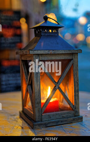 https://l450v.alamy.com/450v/f6394y/view-of-the-lantern-with-a-burning-candle-on-wooden-surface-and-blurred-f6394y.jpg